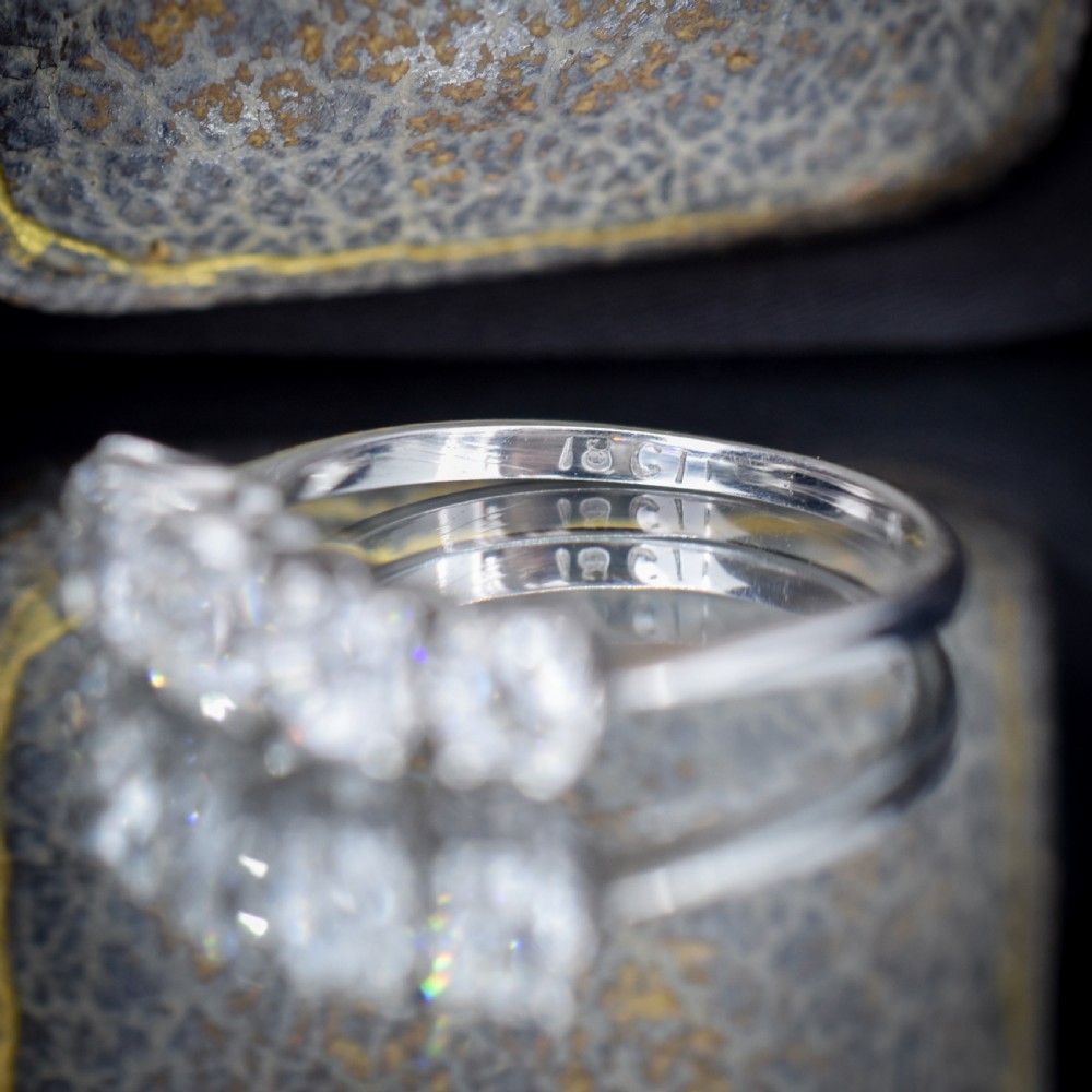 An 18ct white gold five-stone ring set with five graduated old-cut diamonds in claw settings. View IX