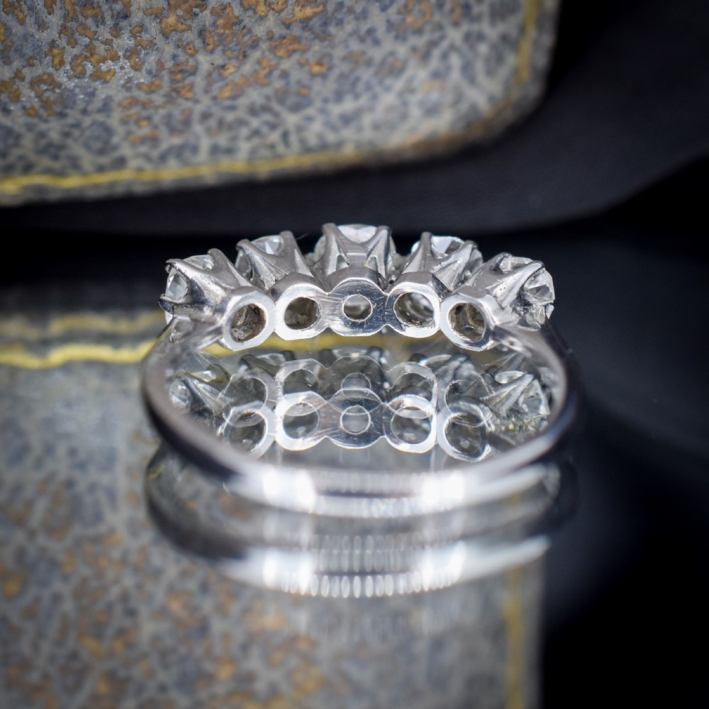 An 18ct white gold five-stone ring set with five graduated old-cut diamonds in claw settings. View X
