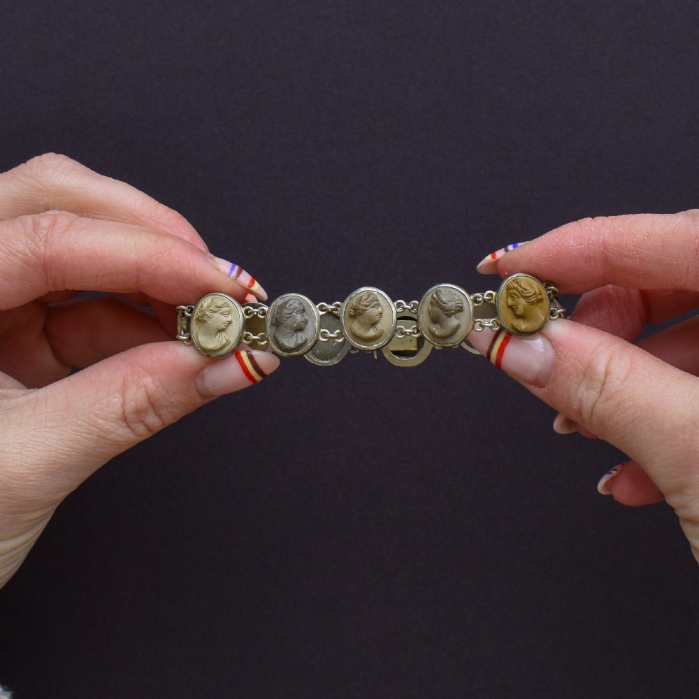 An antique Victorian Grand Tour bracelet featuring oval lava stone cameos carved with classical portrait busts, connected by silver link chains. View IV