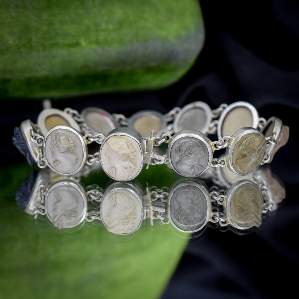An antique Victorian Grand Tour bracelet featuring oval lava stone cameos carved with classical portrait busts, connected by silver link chains. View VII