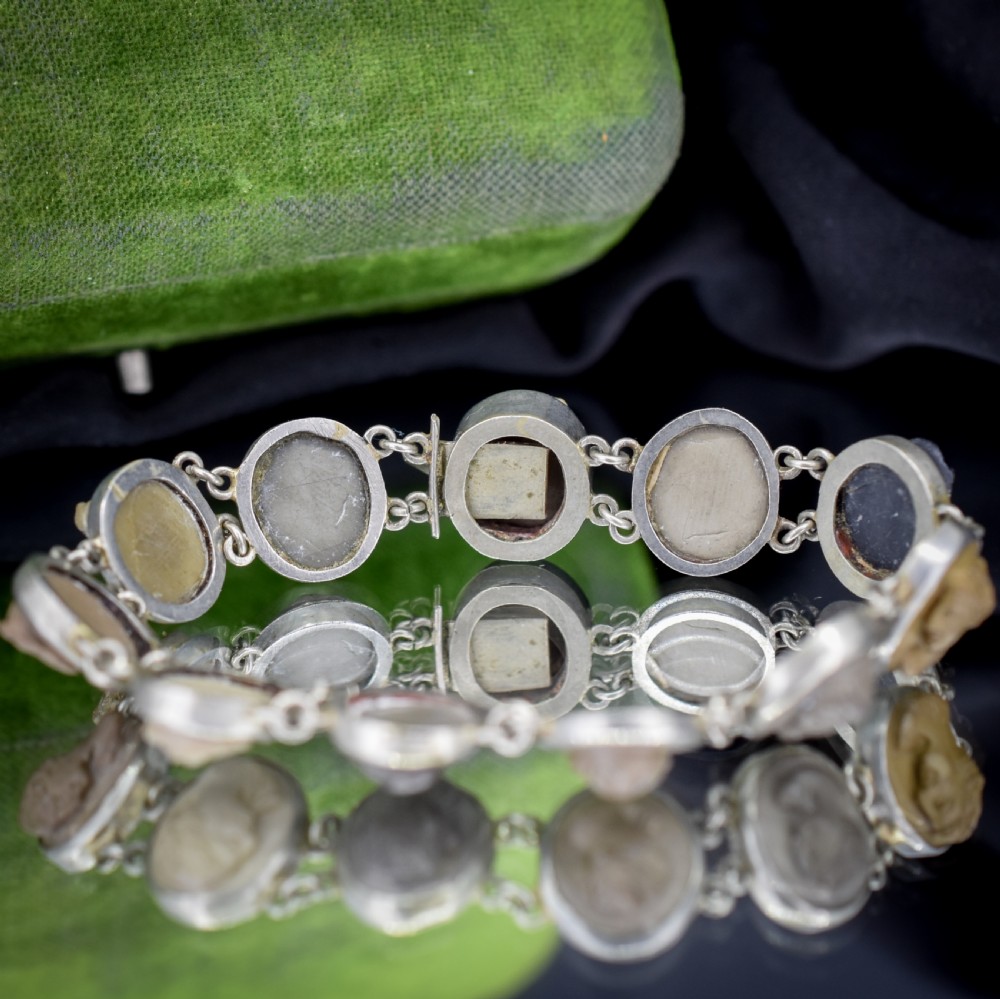 An antique Victorian Grand Tour bracelet featuring oval lava stone cameos carved with classical portrait busts, connected by silver link chains. View X