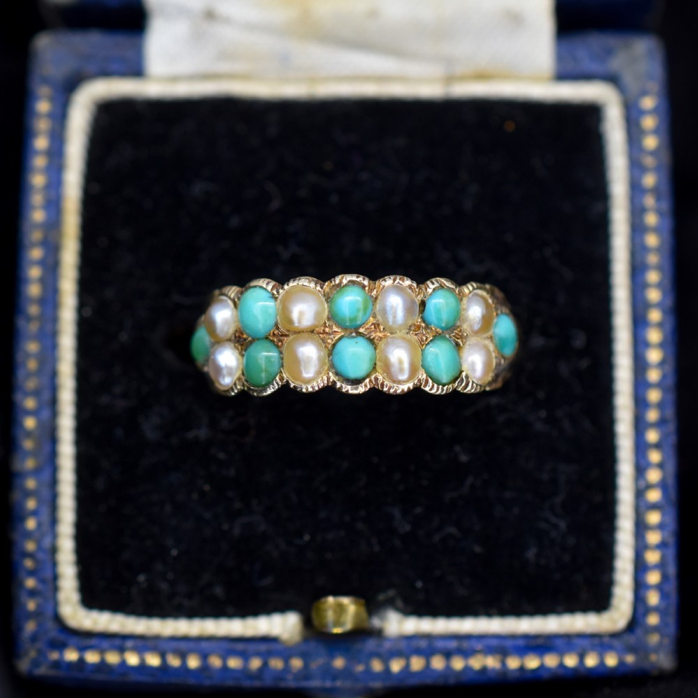 An antique Victorian 12ct gold double row ring set with alternating turquoise cabochons and natural pearls.
