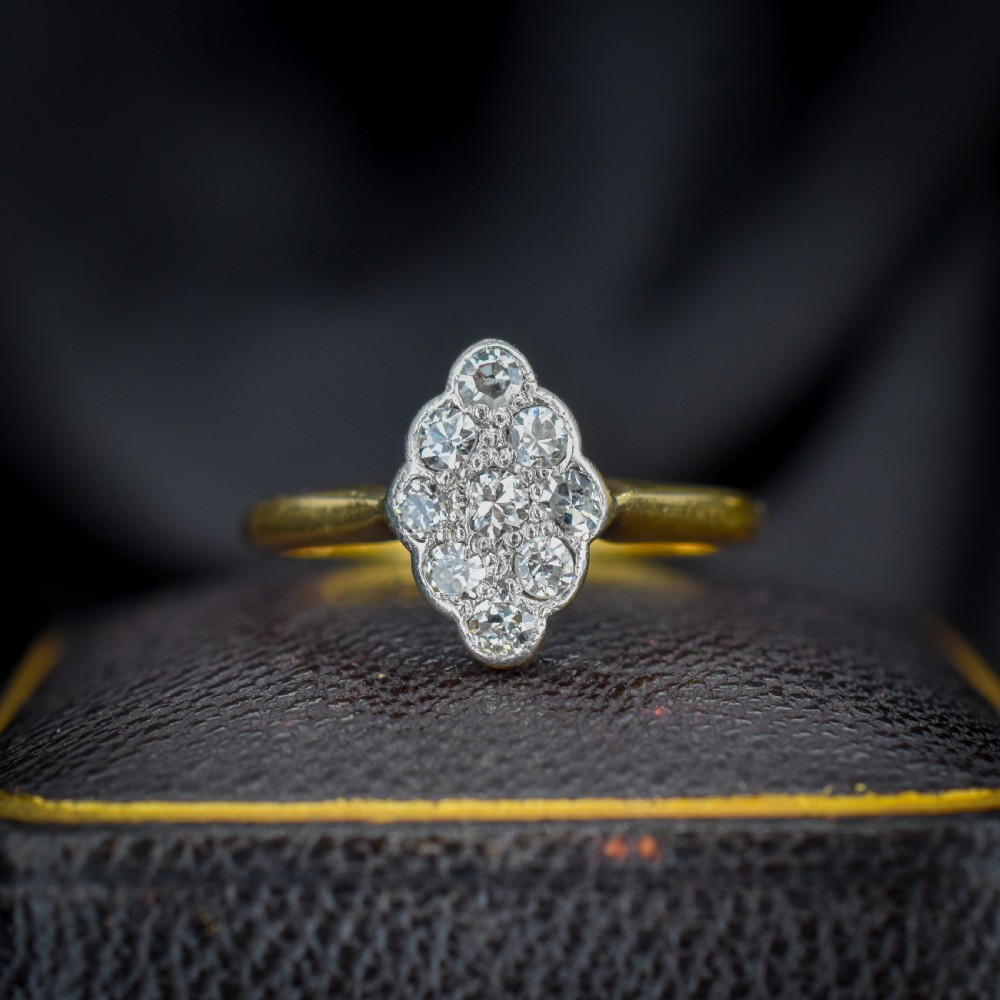 An Art Deco navette cluster ring featuring old-cut diamonds mounted in platinum on an 18ct yellow gold band.