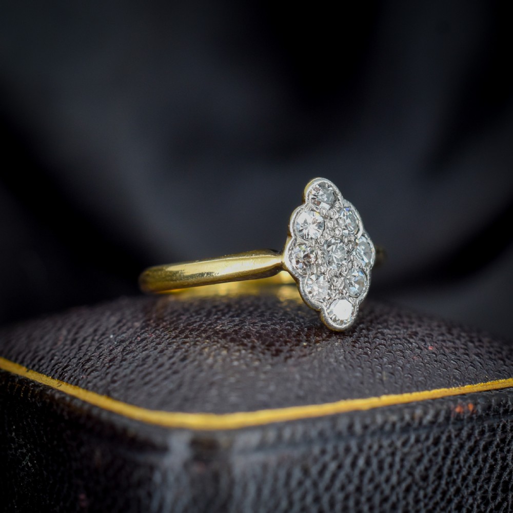 An Art Deco navette cluster ring featuring old-cut diamonds mounted in platinum on an 18ct yellow gold band. View II