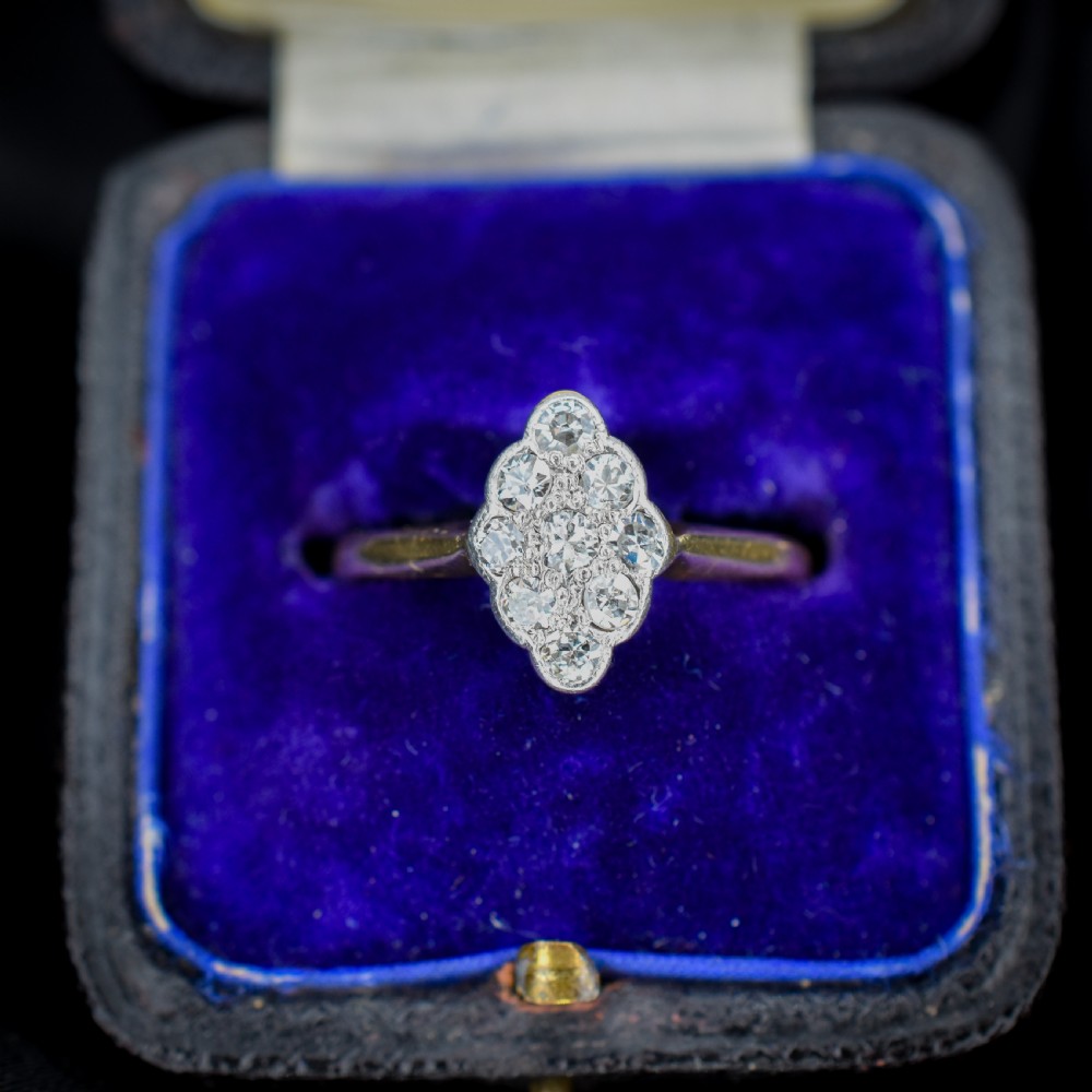 An Art Deco navette cluster ring featuring old-cut diamonds mounted in platinum on an 18ct yellow gold band. View III