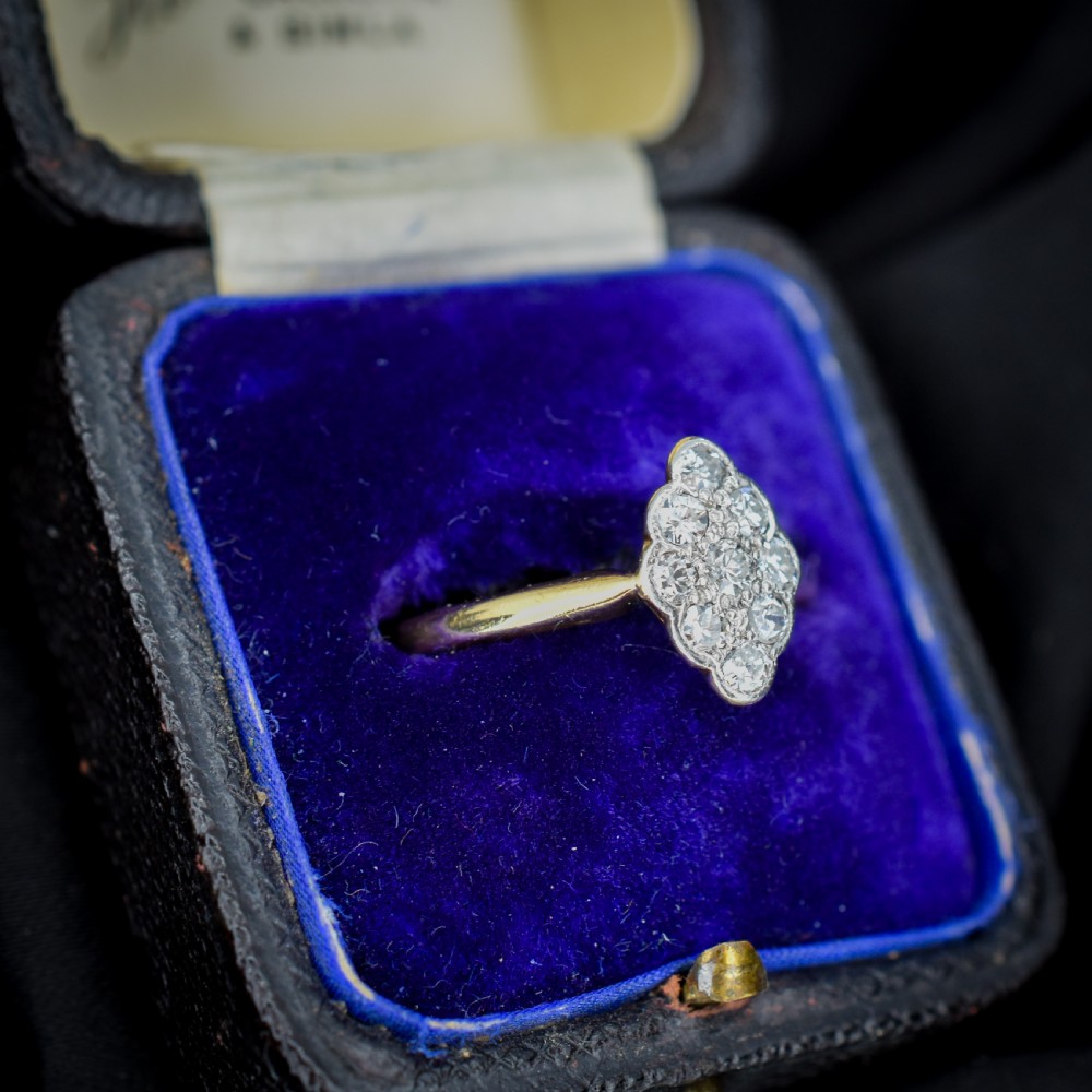 An Art Deco navette cluster ring featuring old-cut diamonds mounted in platinum on an 18ct yellow gold band. View IV