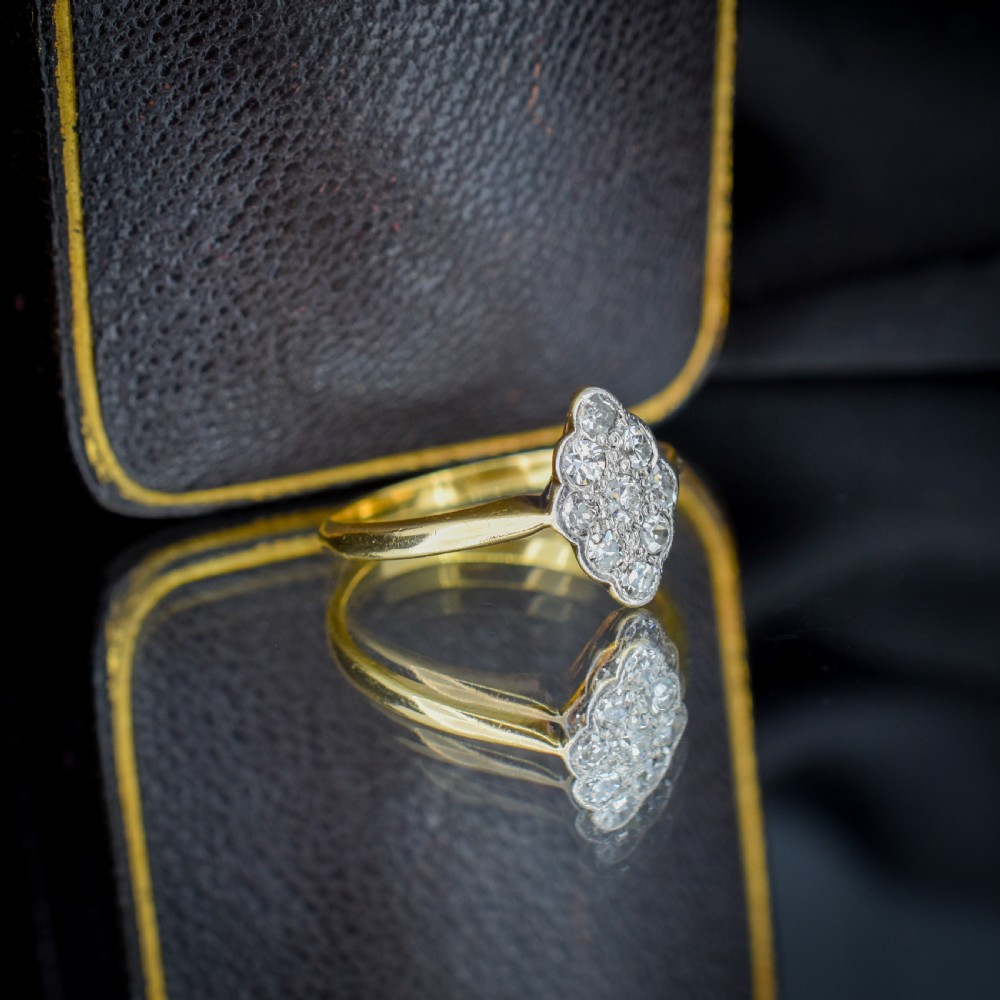 An Art Deco navette cluster ring featuring old-cut diamonds mounted in platinum on an 18ct yellow gold band. View V