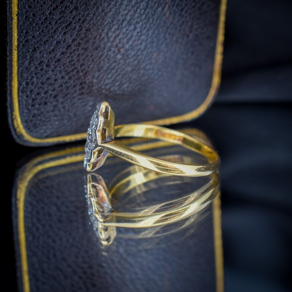 An Art Deco navette cluster ring featuring old-cut diamonds mounted in platinum on an 18ct yellow gold band. View VI