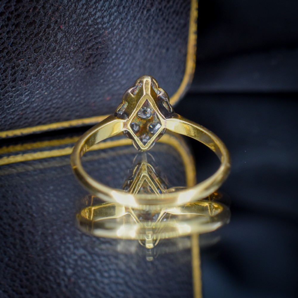An Art Deco navette cluster ring featuring old-cut diamonds mounted in platinum on an 18ct yellow gold band. View VII