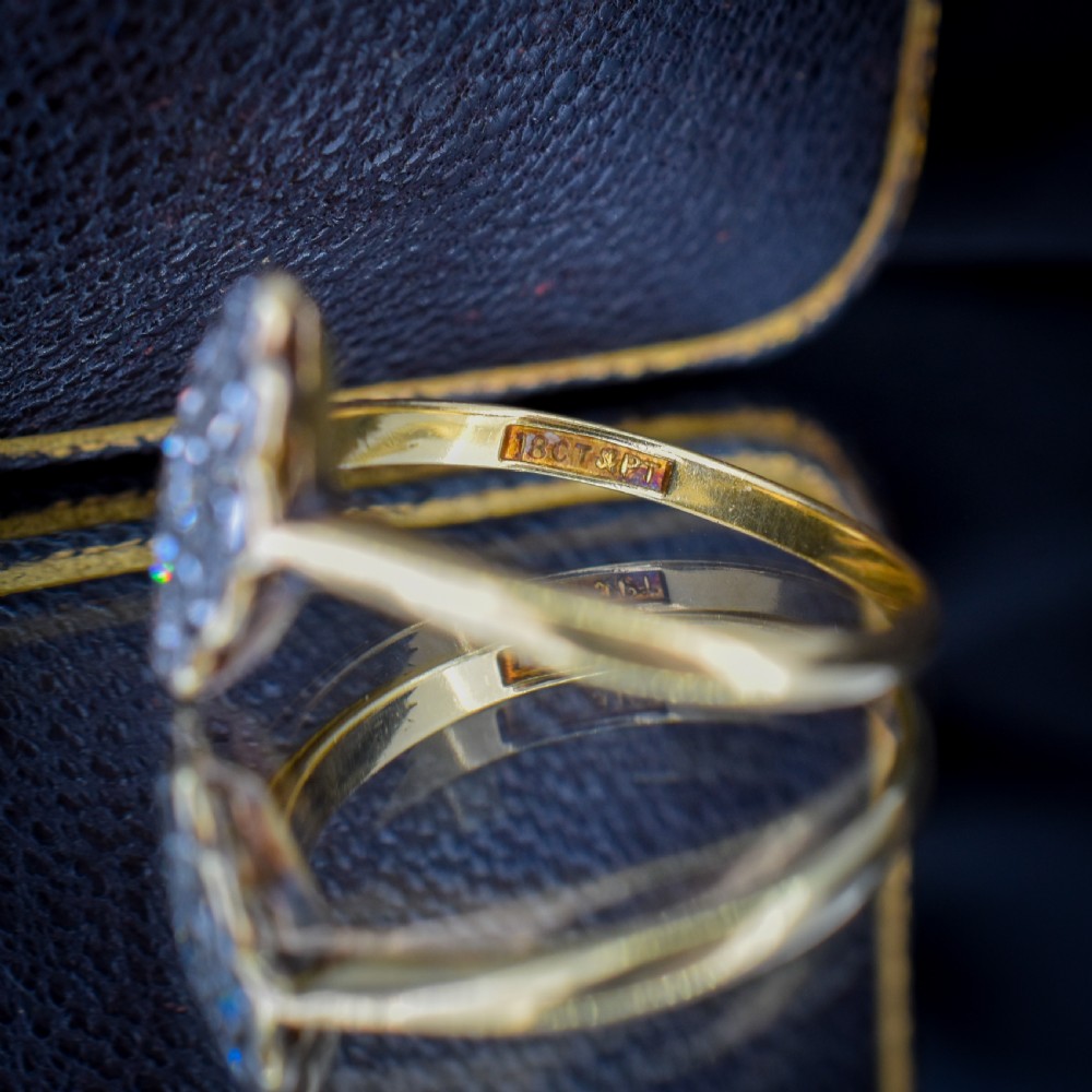 An Art Deco navette cluster ring featuring old-cut diamonds mounted in platinum on an 18ct yellow gold band. View VIII