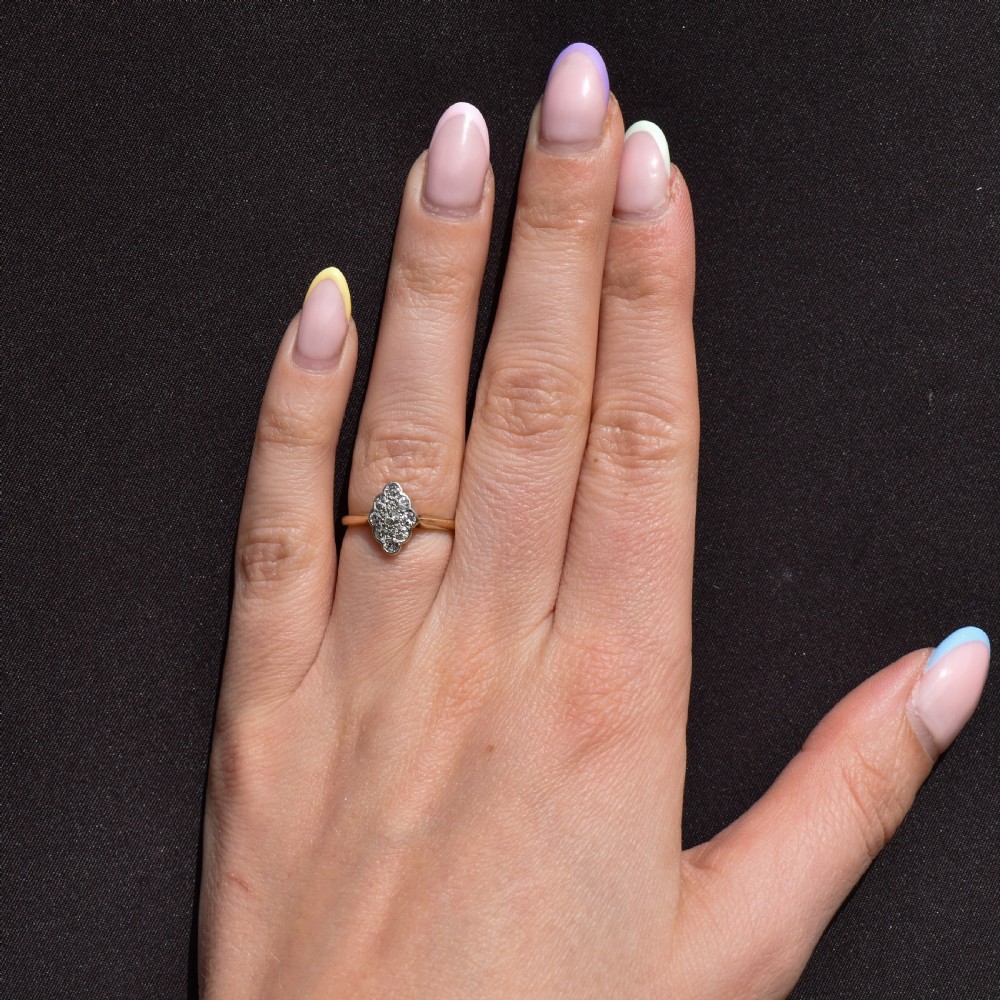 An Art Deco navette cluster ring featuring old-cut diamonds mounted in platinum on an 18ct yellow gold band. View XI