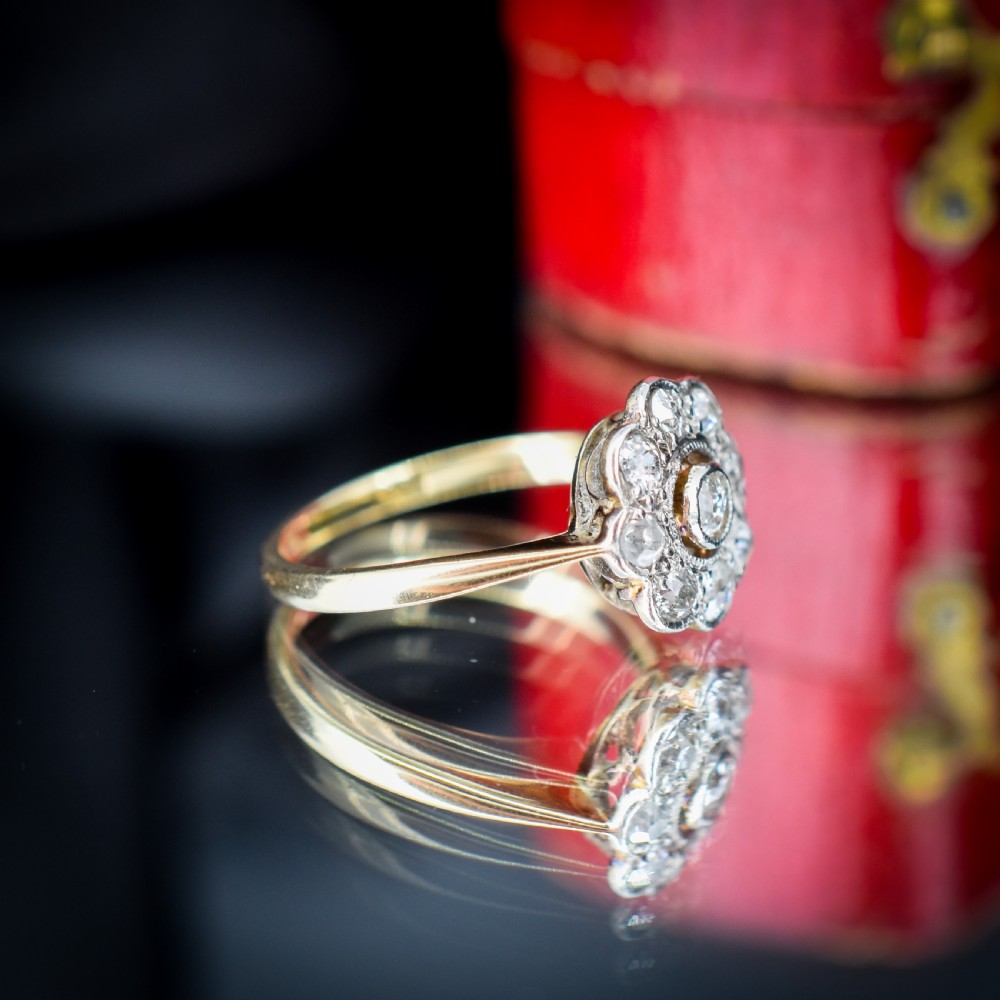 An antique diamond cluster ring in a flower shape set in platinum with an 18ct yellow gold band. View VIII