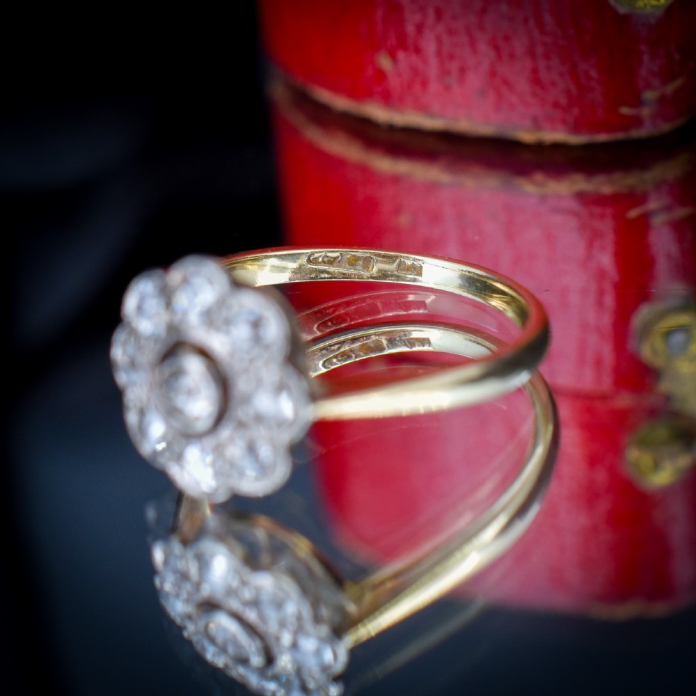 An antique diamond cluster ring in a flower shape set in platinum with an 18ct yellow gold band. View XI