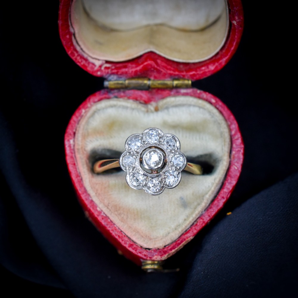 An antique diamond cluster ring in a flower shape set in platinum with an 18ct yellow gold band. View XII
