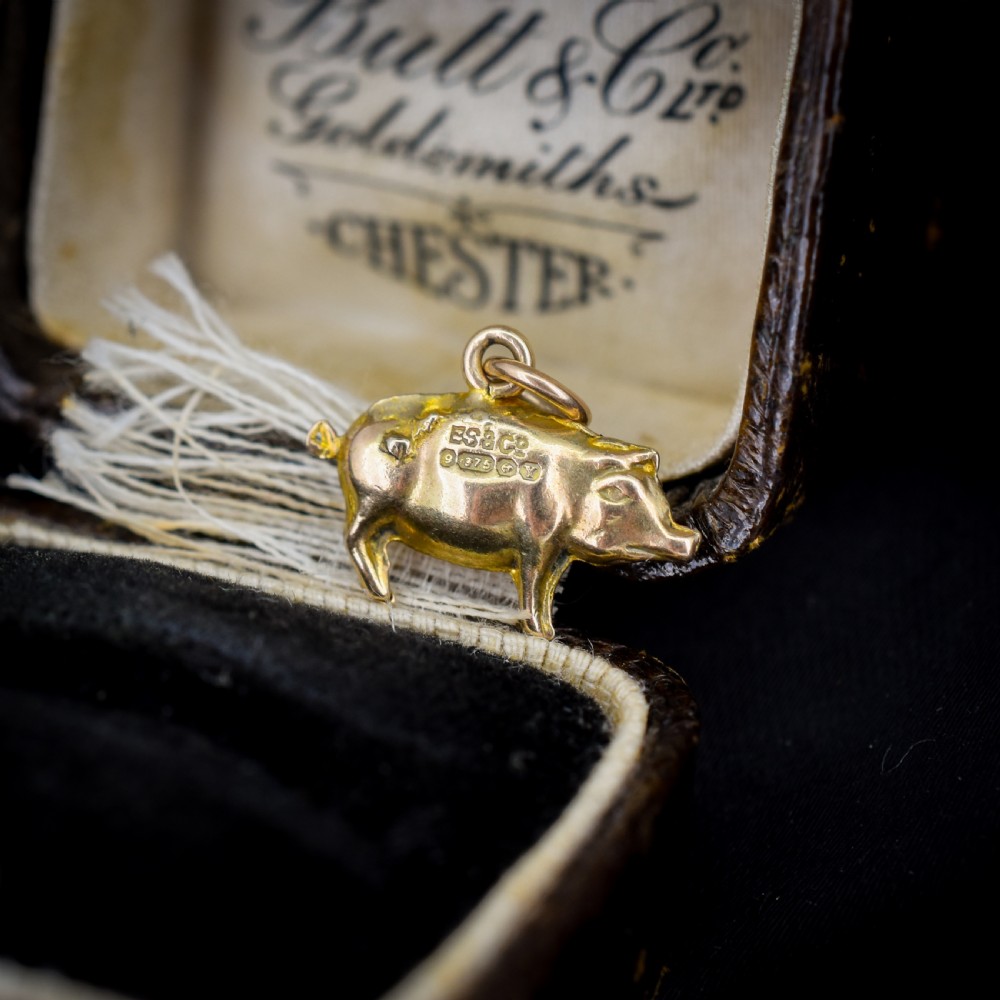 A solid 9ct yellow gold charm shaped as a standing boxer dog with visible hallmarks stamped on its side. View III