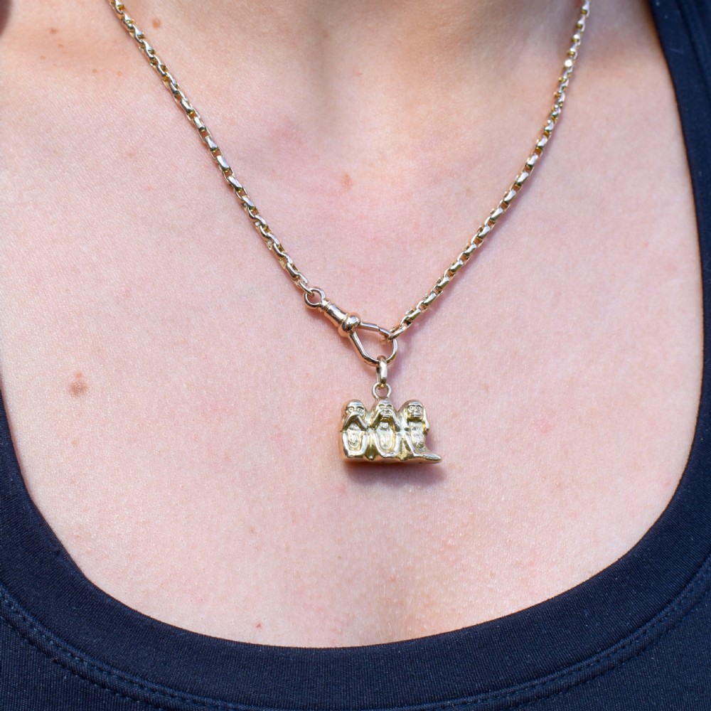 A solid 9ct yellow gold charm shaped as a standing boxer dog with visible hallmarks stamped on its side. View XI