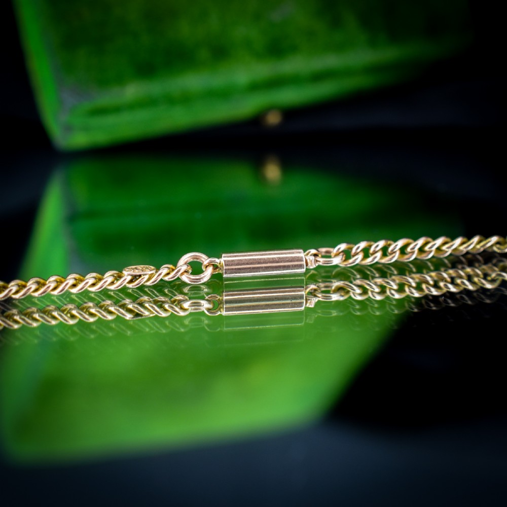An antique 9ct yellow gold flat curb link chain necklace featuring a cylindrical barrel clasp. View VI