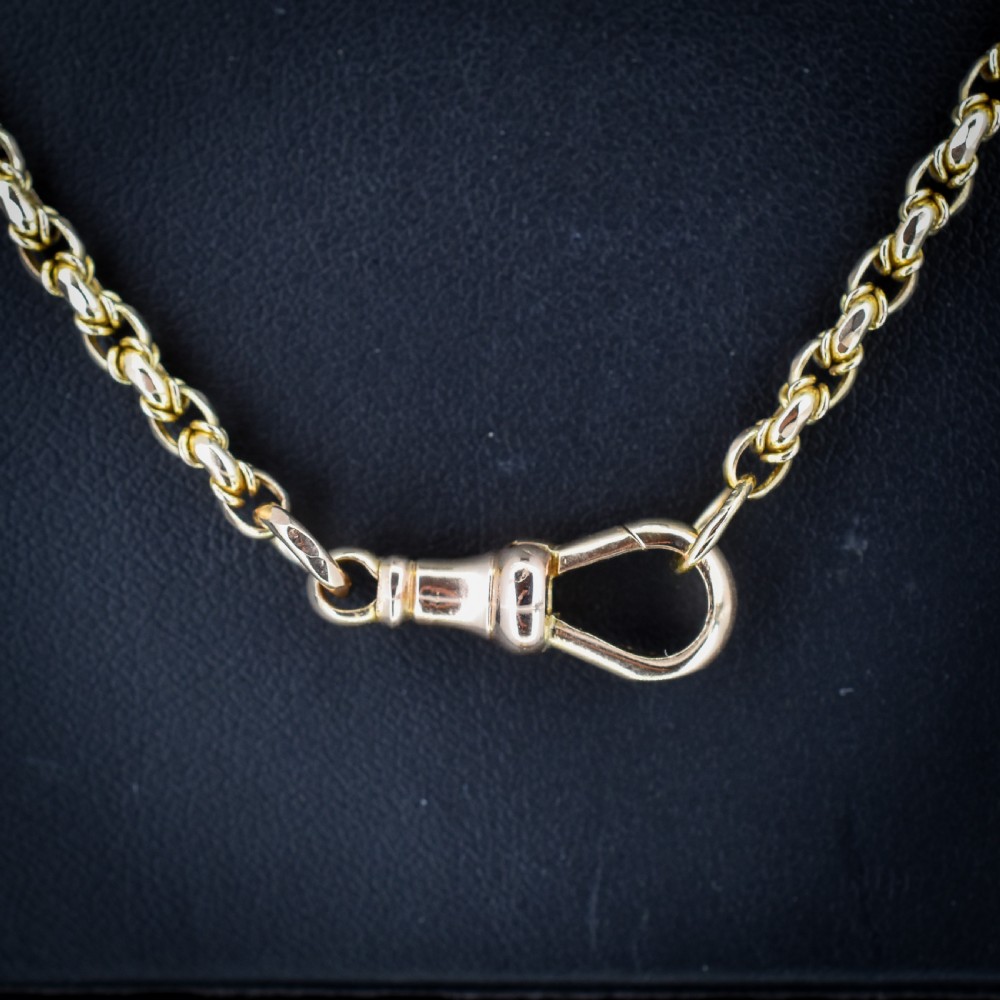 An antique 9ct yellow gold fancy link chain necklace featuring an elongated dog clip fastener. View IV