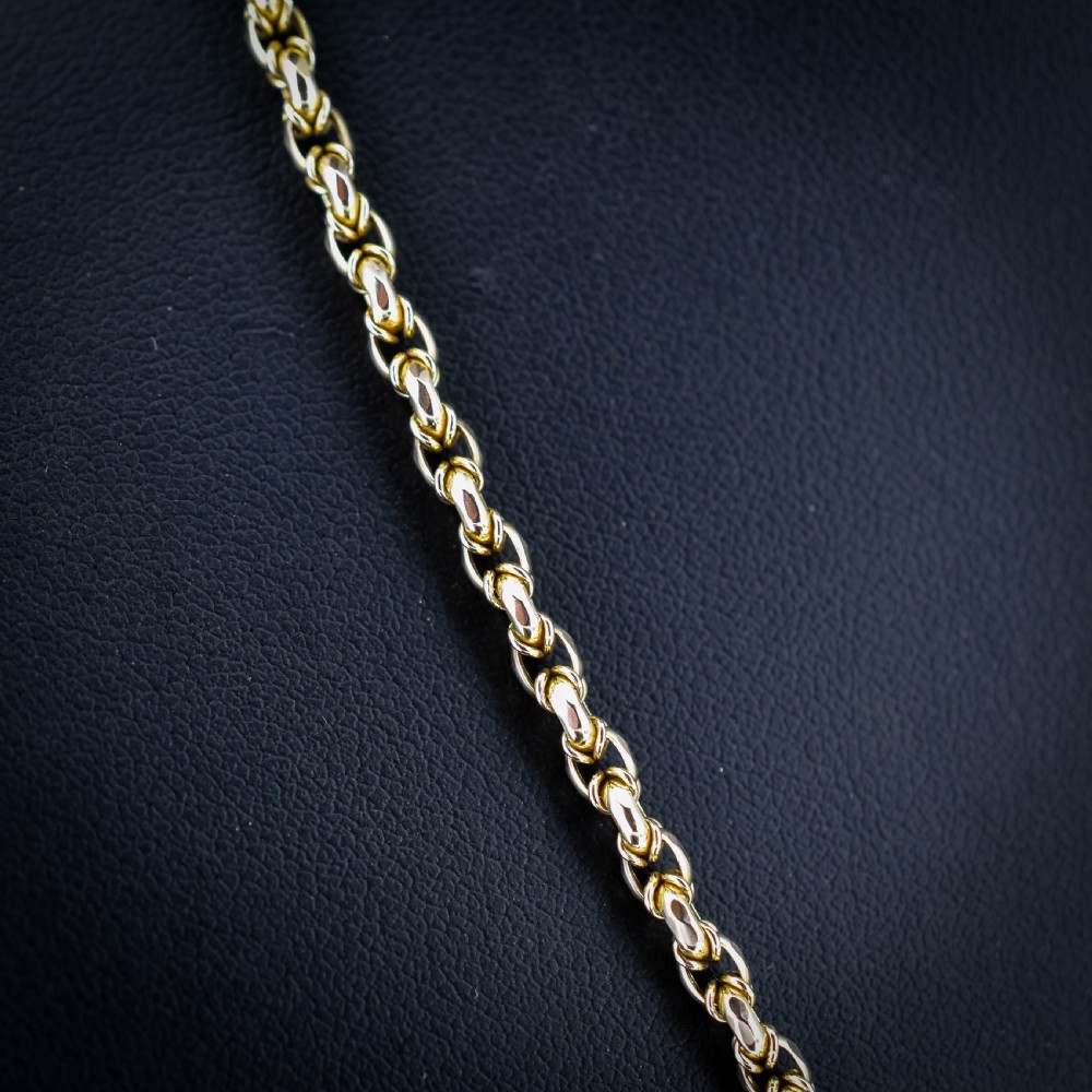An antique 9ct yellow gold fancy link chain necklace featuring an elongated dog clip fastener. View V