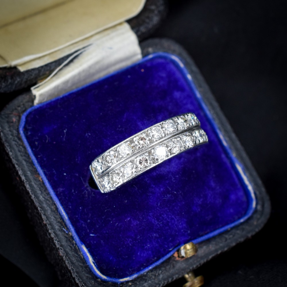An Art Deco double row diamond half eternity ring set in 18ct white gold with channel-set round diamonds. View IV