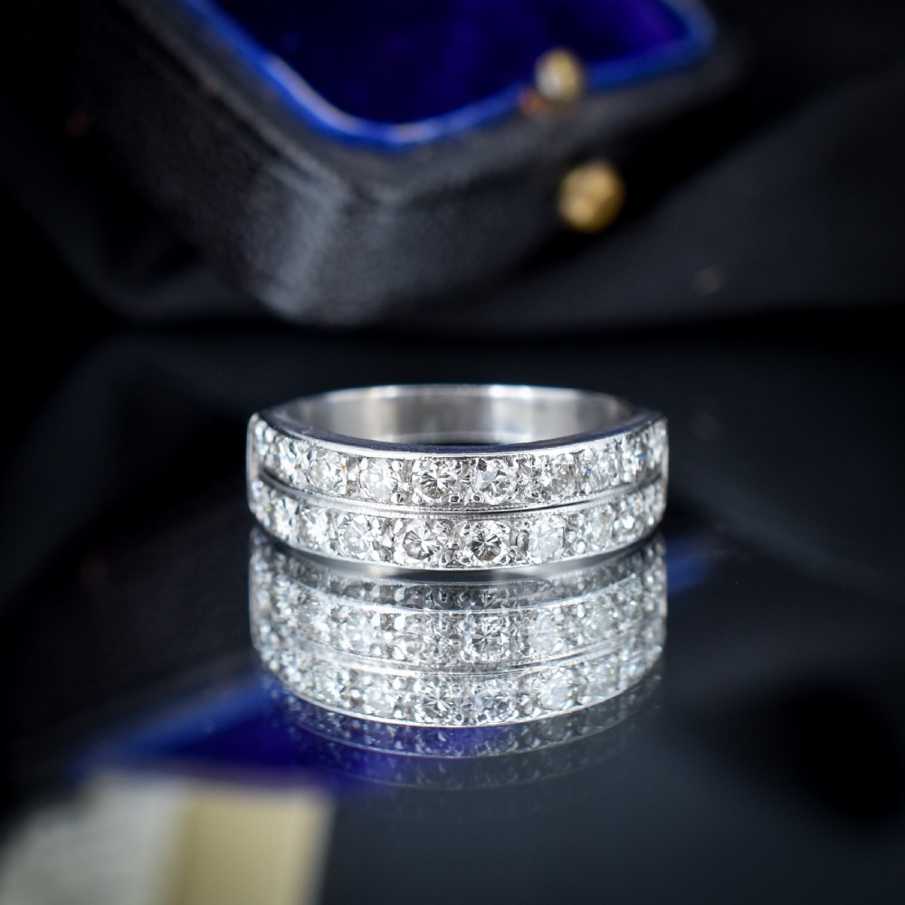 An Art Deco double row diamond half eternity ring set in 18ct white gold with channel-set round diamonds. View V