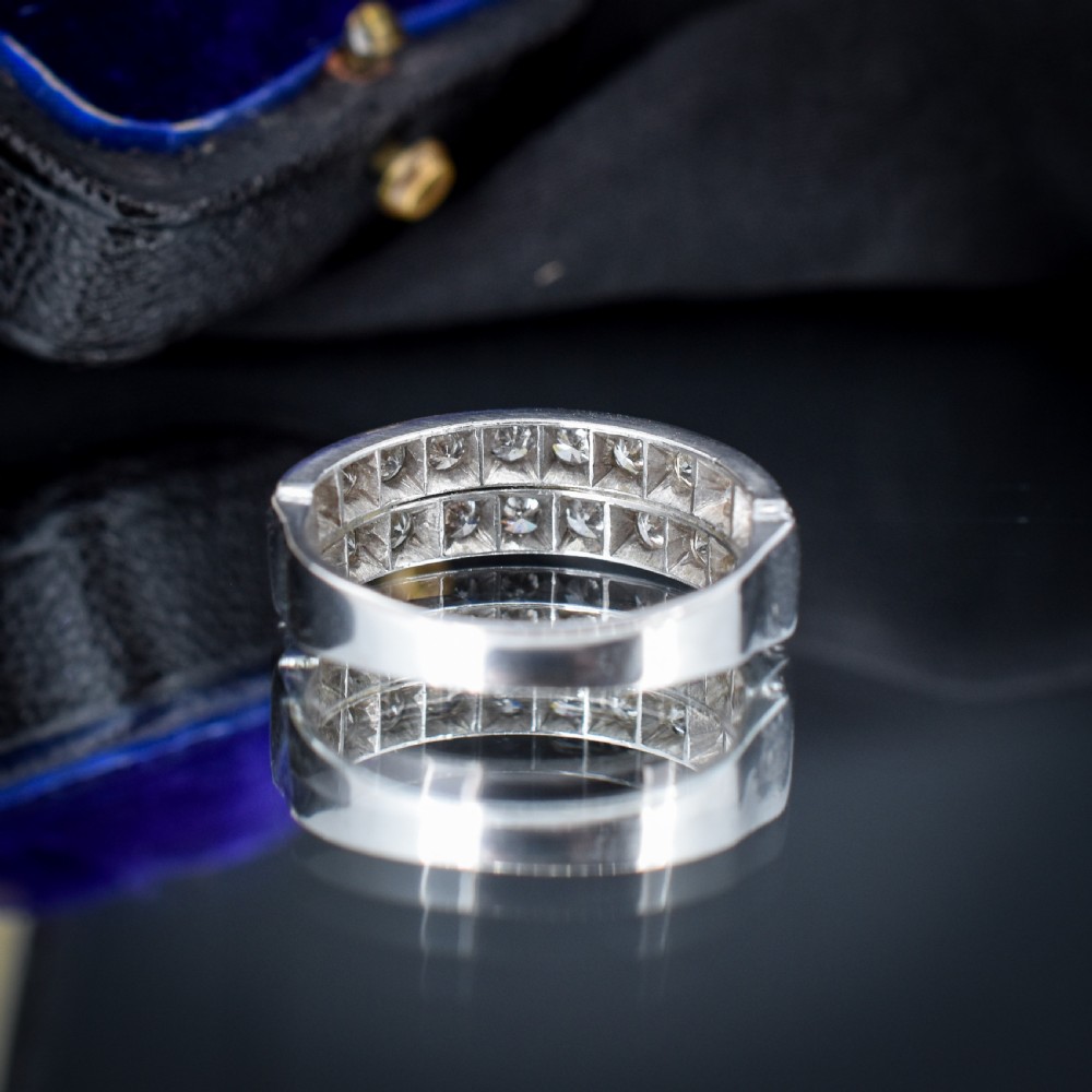 An Art Deco double row diamond half eternity ring set in 18ct white gold with channel-set round diamonds. View VI