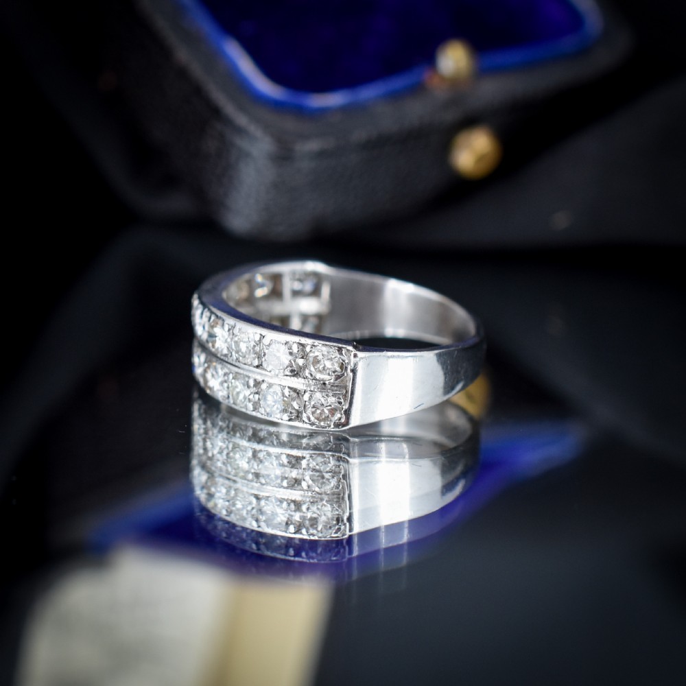 An Art Deco double row diamond half eternity ring set in 18ct white gold with channel-set round diamonds. View VIII