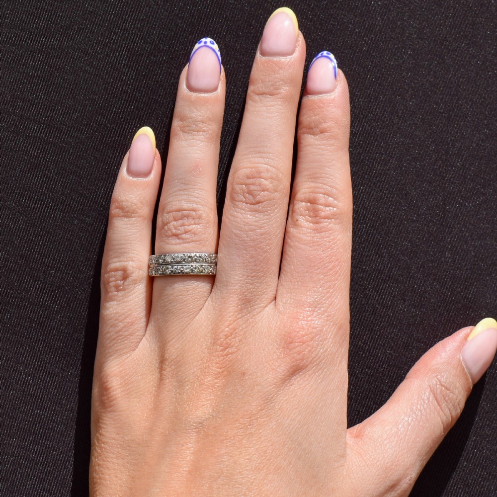 An Art Deco double row diamond half eternity ring set in 18ct white gold with channel-set round diamonds. View X
