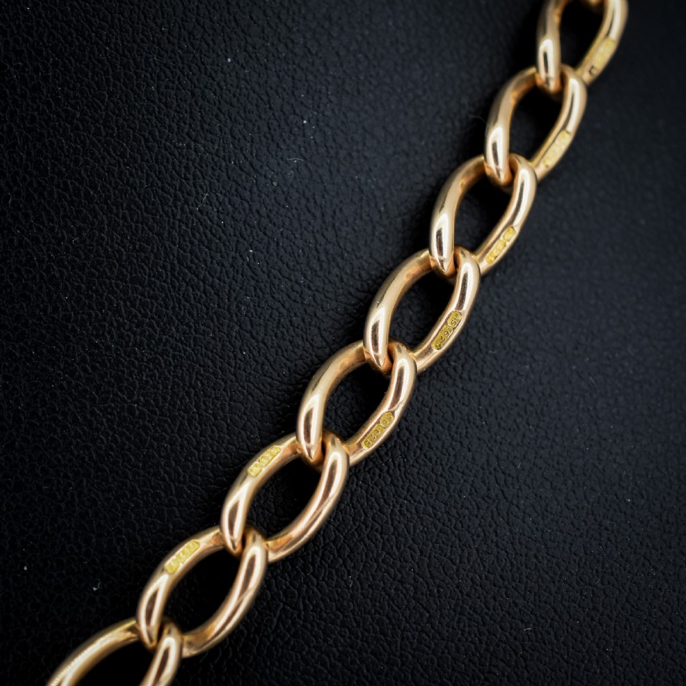 An antique 15ct yellow gold oval link Albert watch chain necklace featuring a suspended T-bar element. View IV