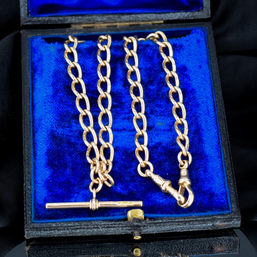 An antique 15ct yellow gold oval link Albert watch chain necklace featuring a suspended T-bar element. View V