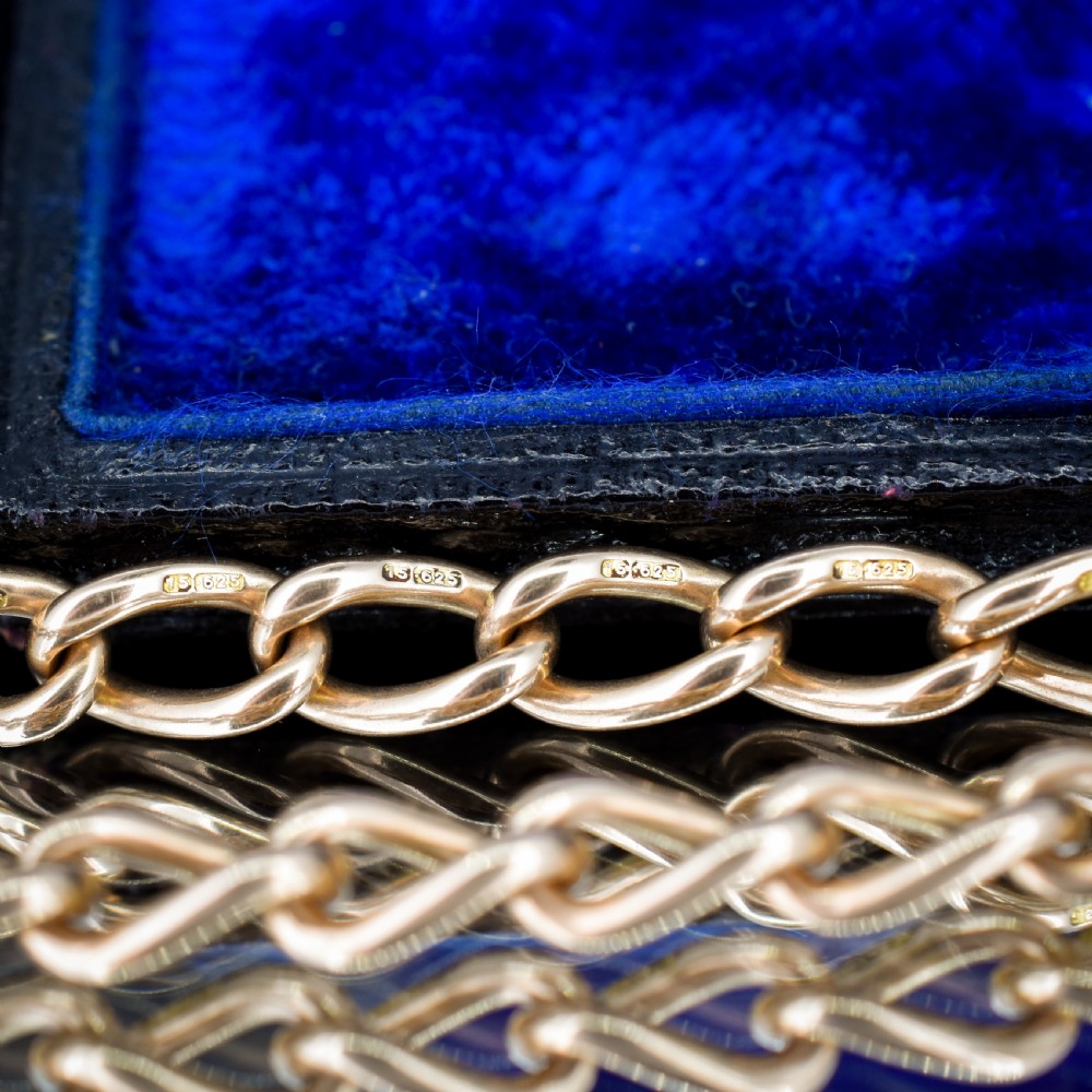 An antique 15ct yellow gold oval link Albert watch chain necklace featuring a suspended T-bar element. View IX