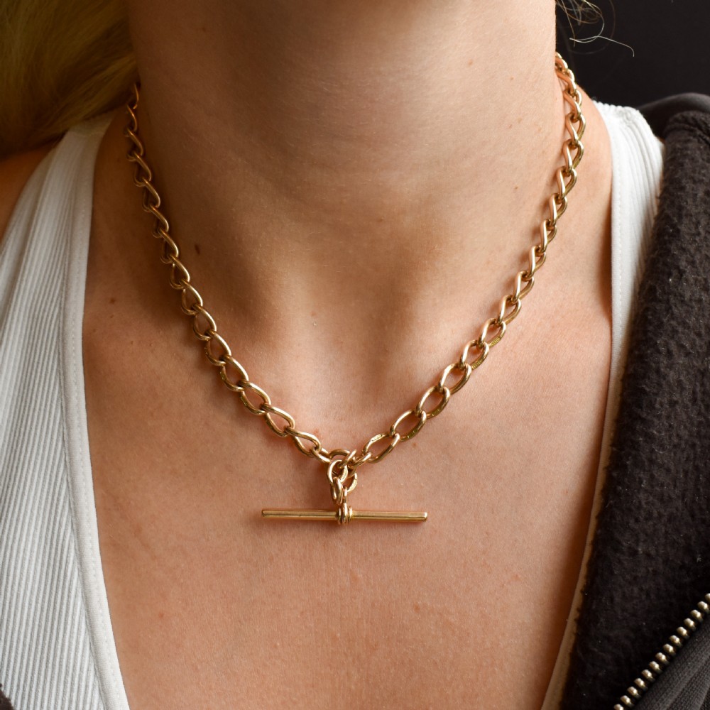 An antique 15ct yellow gold oval link Albert watch chain necklace featuring a suspended T-bar element. View XI