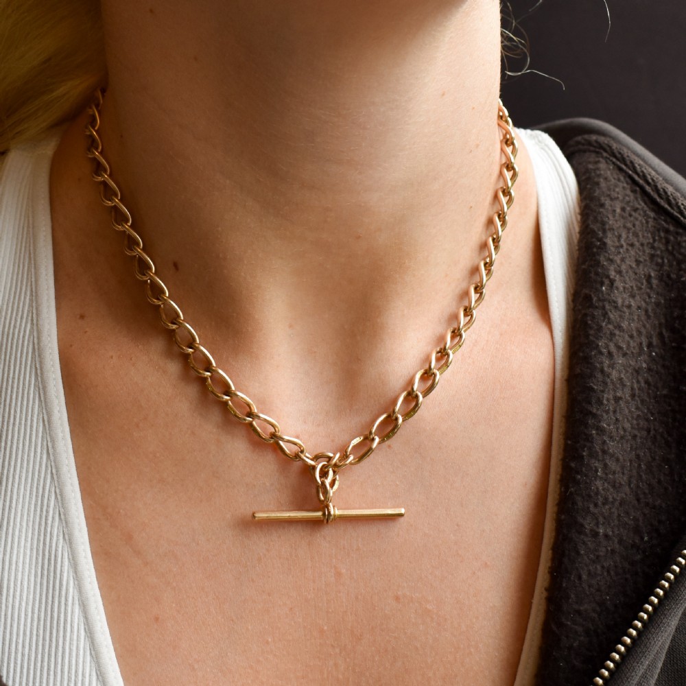 An antique 15ct yellow gold oval link Albert watch chain necklace featuring a suspended T-bar element. View XII