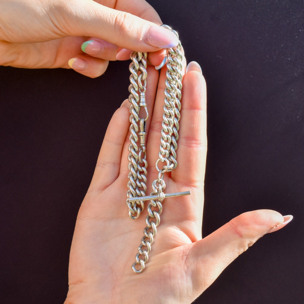 An antique 15ct yellow gold curb link Albert watch chain featuring a T-bar, dog clip, and bolt ring fastener, displayed inside a velvet fitted box. View IX
