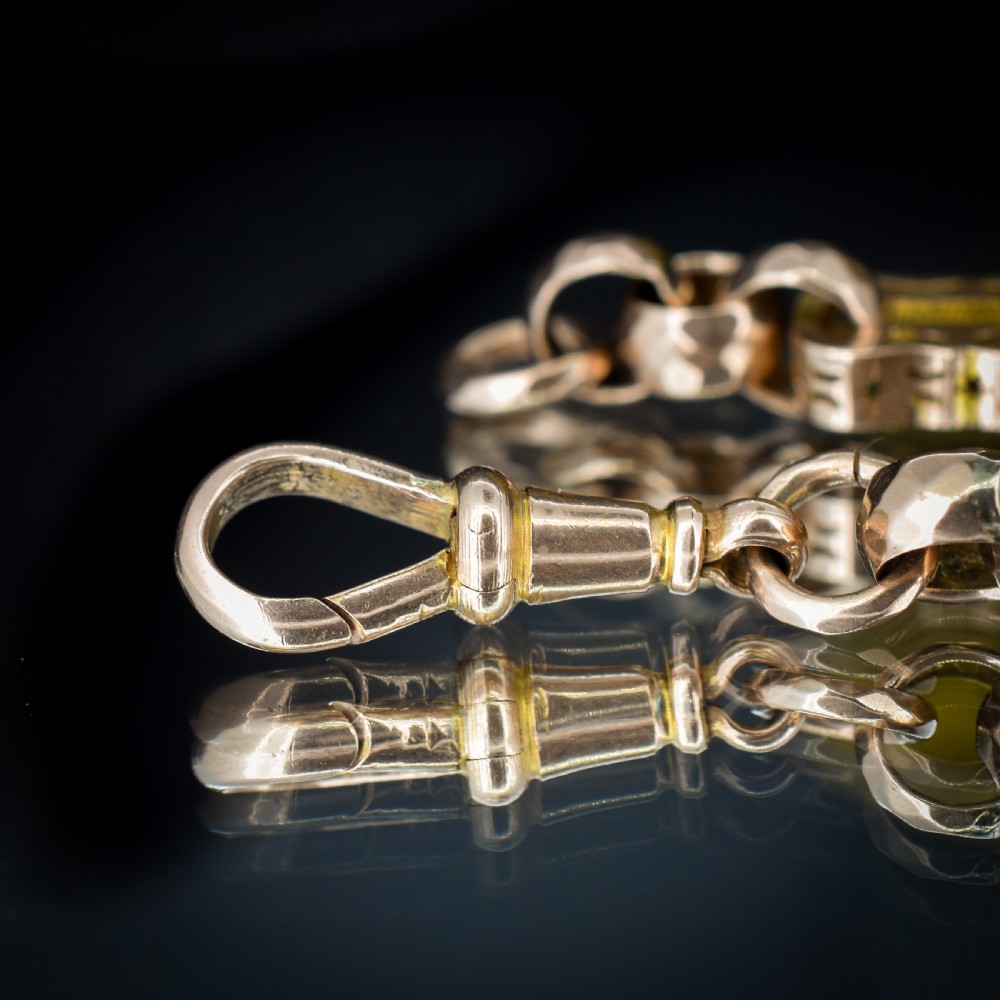 An antique 9ct gold chain bracelet featuring alternating star-and-bar decorative links and faceted round links with a swivel clasp. View III