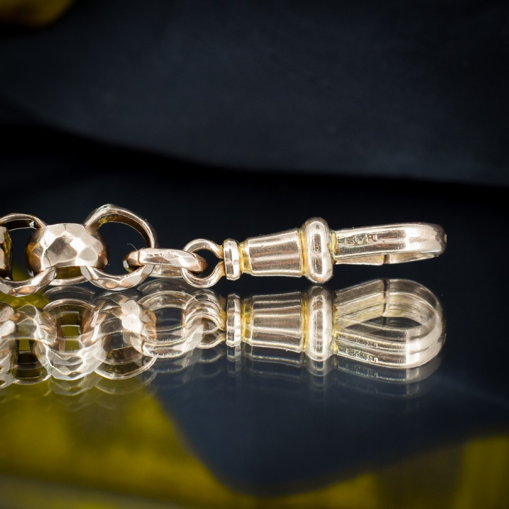 An antique 9ct gold chain bracelet featuring alternating star-and-bar decorative links and faceted round links with a swivel clasp. View V