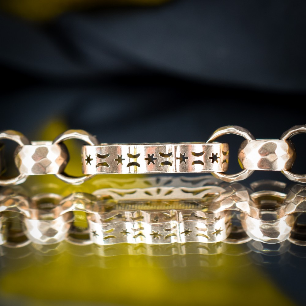 An antique 9ct gold chain bracelet featuring alternating star-and-bar decorative links and faceted round links with a swivel clasp. View VI