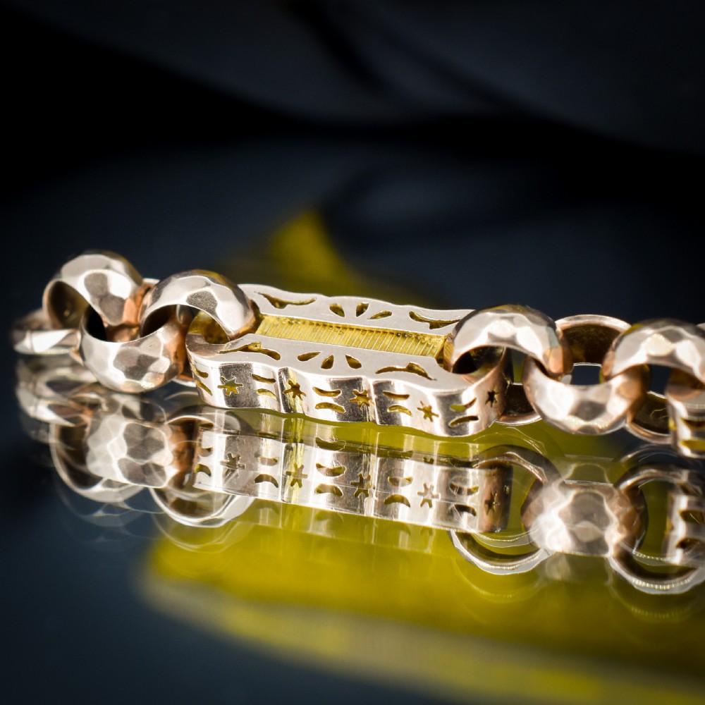 An antique 9ct gold chain bracelet featuring alternating star-and-bar decorative links and faceted round links with a swivel clasp. View VII