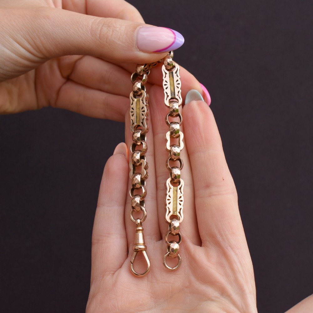 An antique 9ct gold chain bracelet featuring alternating star-and-bar decorative links and faceted round links with a swivel clasp. View IX
