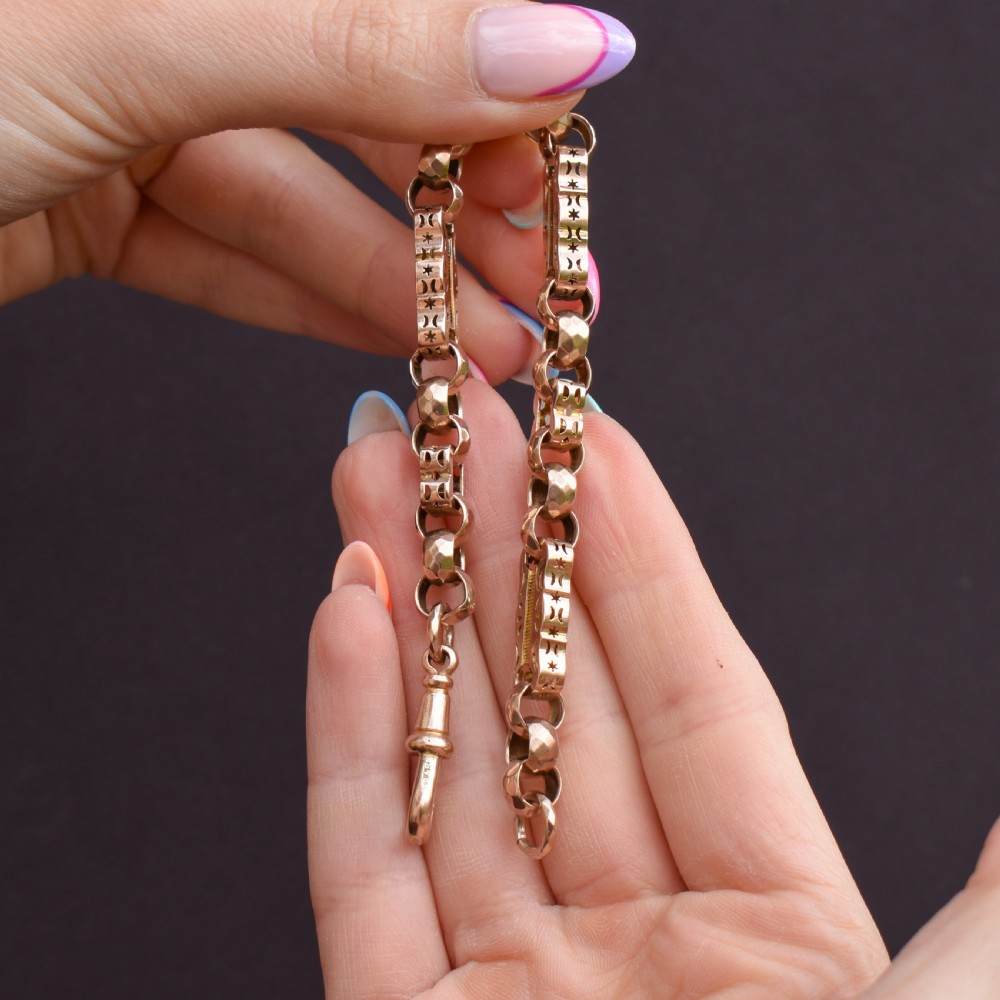An antique 9ct gold chain bracelet featuring alternating star-and-bar decorative links and faceted round links with a swivel clasp. View XII
