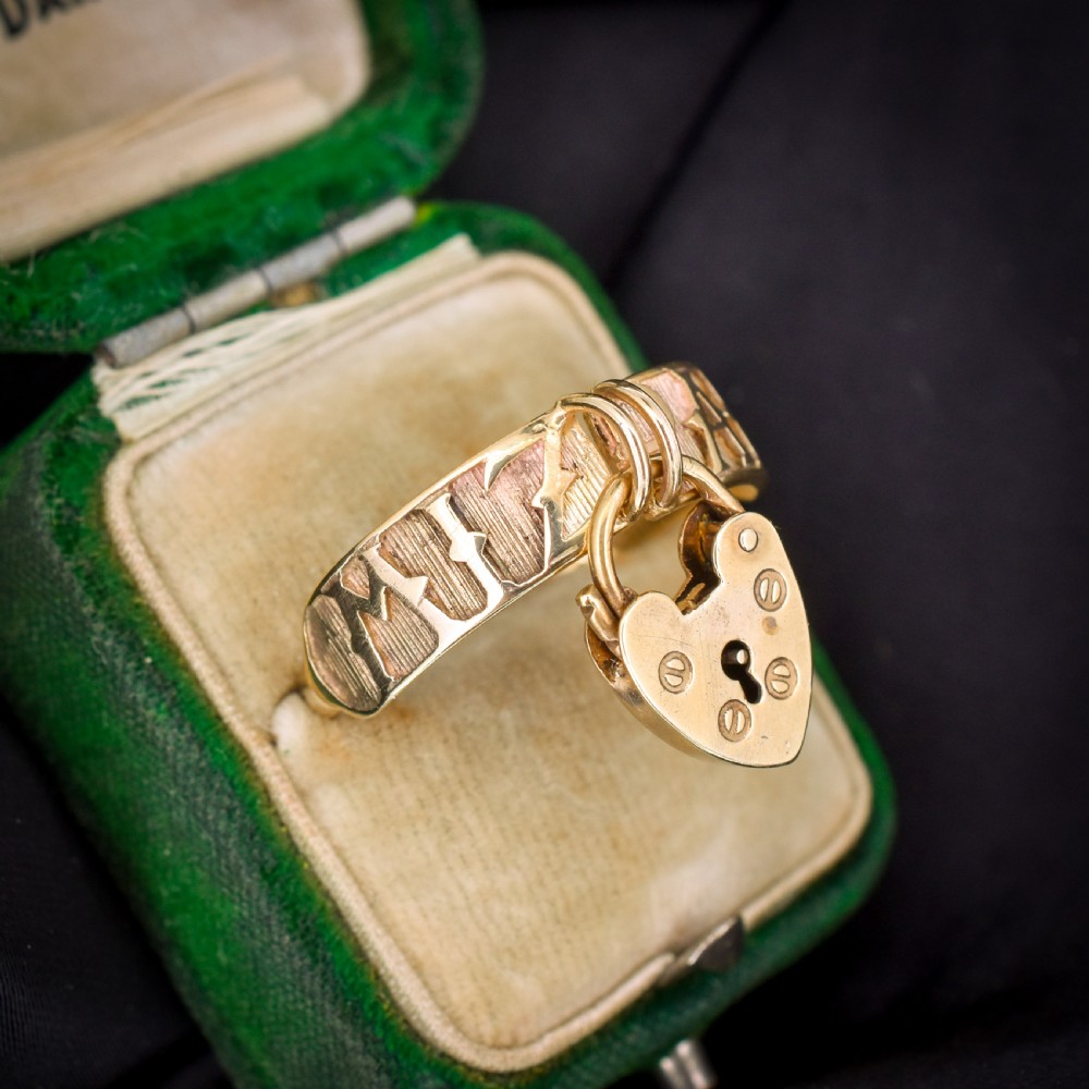 A vintage 9ct yellow gold band ring featuring relief MIZPAH lettering and a dangling heart padlock charm. View II