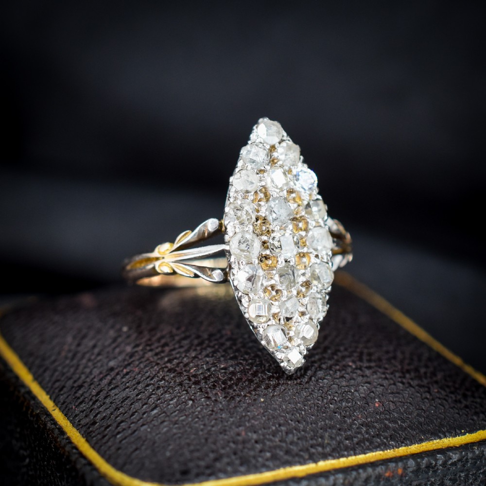 A Victorian 18ct gold navette ring featuring a cluster of multiple old-cut diamonds set in silver-topped shoulders and head. View II