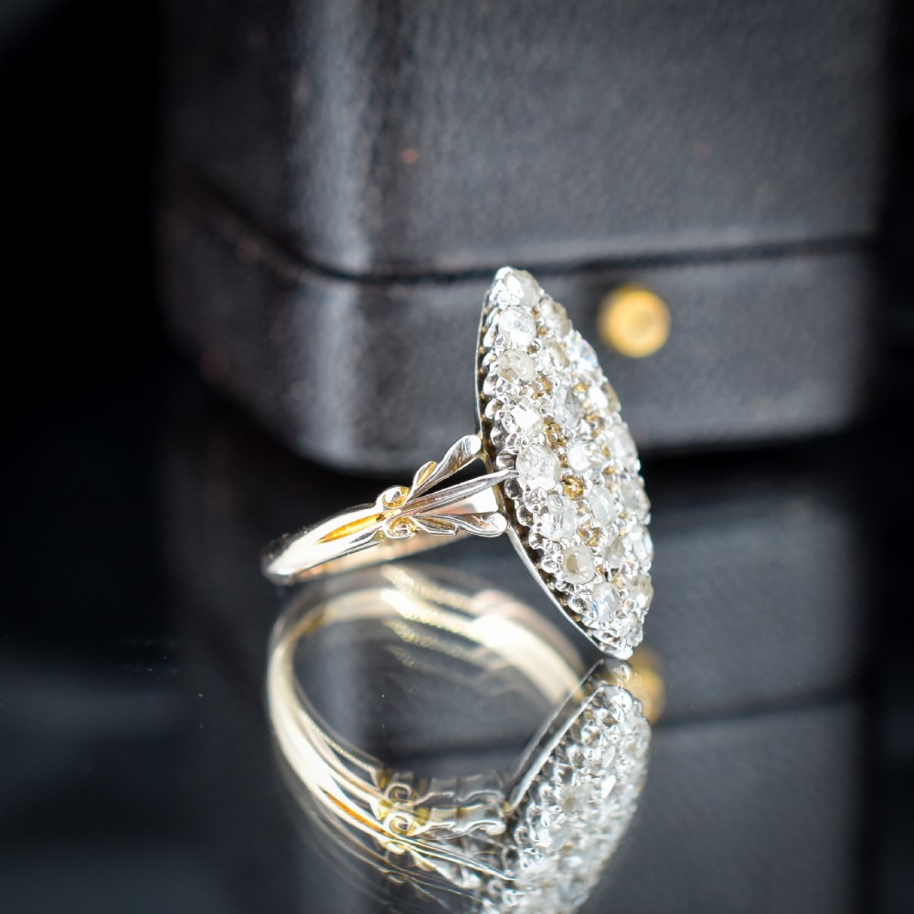 A Victorian 18ct gold navette ring featuring a cluster of multiple old-cut diamonds set in silver-topped shoulders and head. View III
