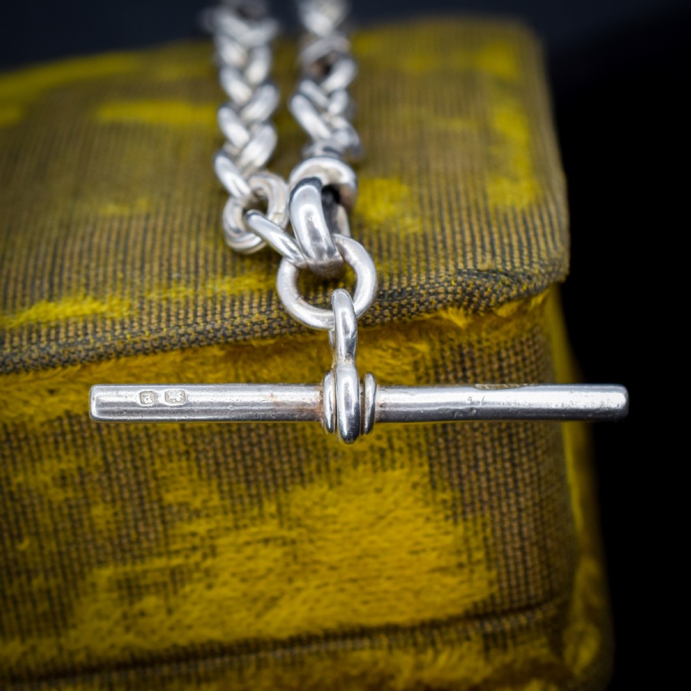 An antique sterling silver fancy link chain bracelet featuring a dog clip fastener and a suspended T-bar drop. View III