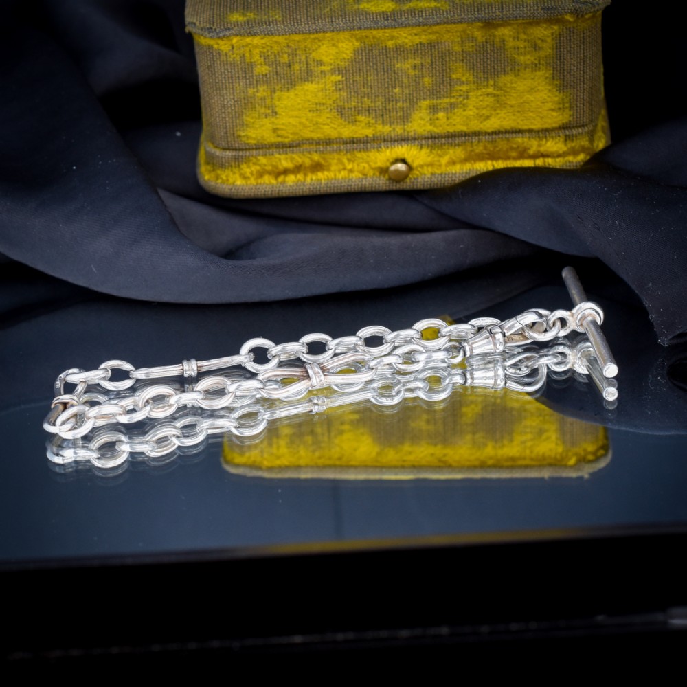 An antique sterling silver fancy link chain bracelet featuring a dog clip fastener and a suspended T-bar drop. View VI