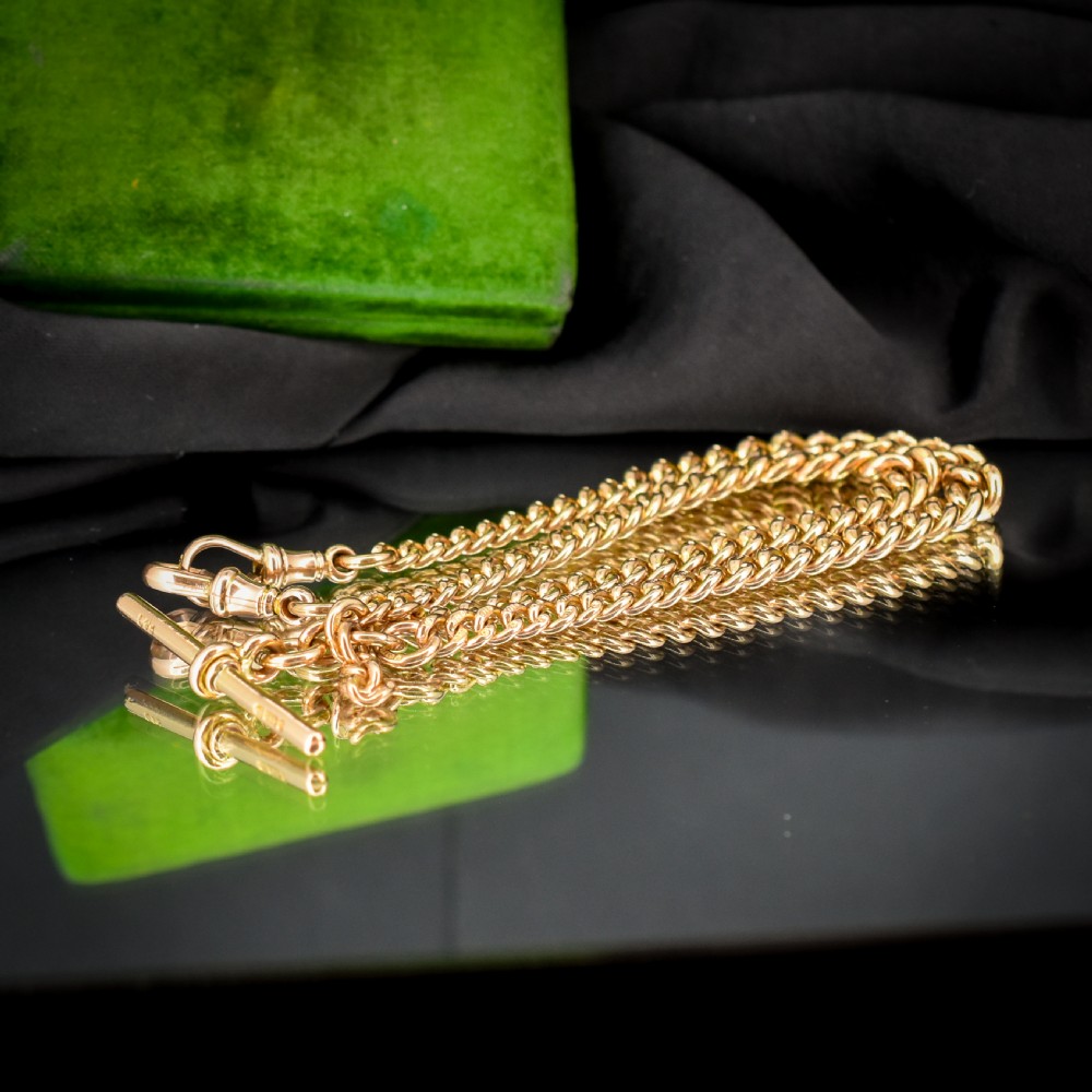 An antique 9ct yellow gold curb link Albert watch chain featuring a central T-bar drop and swivel dog clip fasteners. View II