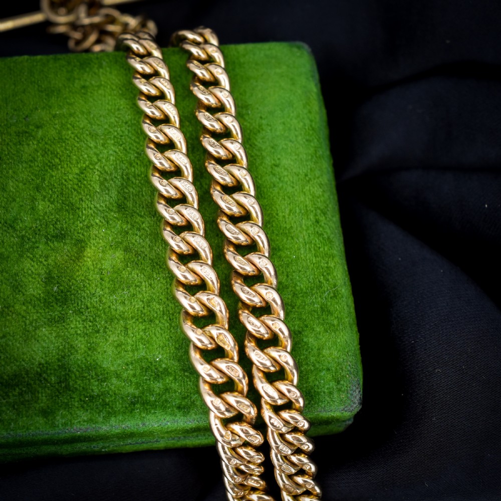 An antique 9ct yellow gold curb link Albert watch chain featuring a central T-bar drop and swivel dog clip fasteners. View V