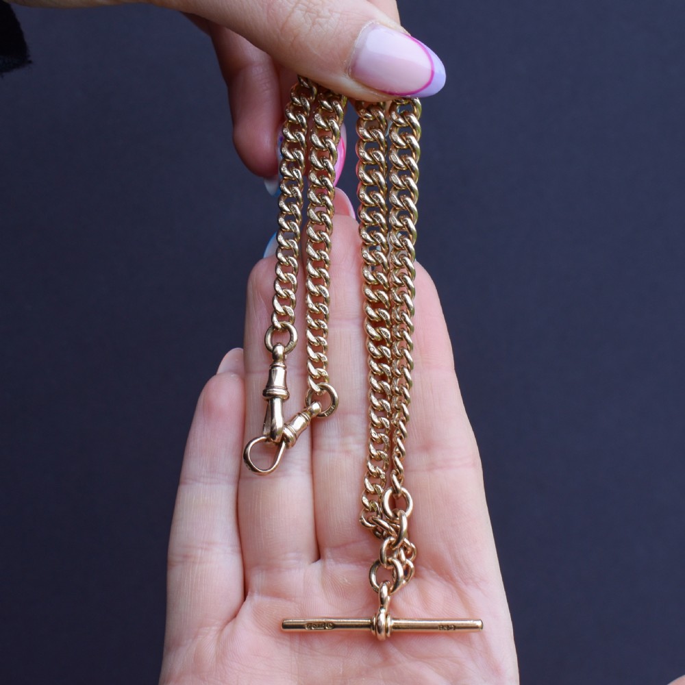 An antique 9ct yellow gold curb link Albert watch chain featuring a central T-bar drop and swivel dog clip fasteners. View VI