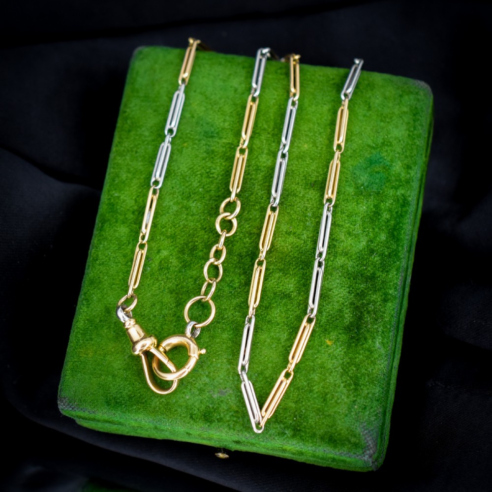 An antique two-tone chain necklace featuring alternating 18ct yellow gold and platinum elongated links with a dog clip and bolt ring clasp.