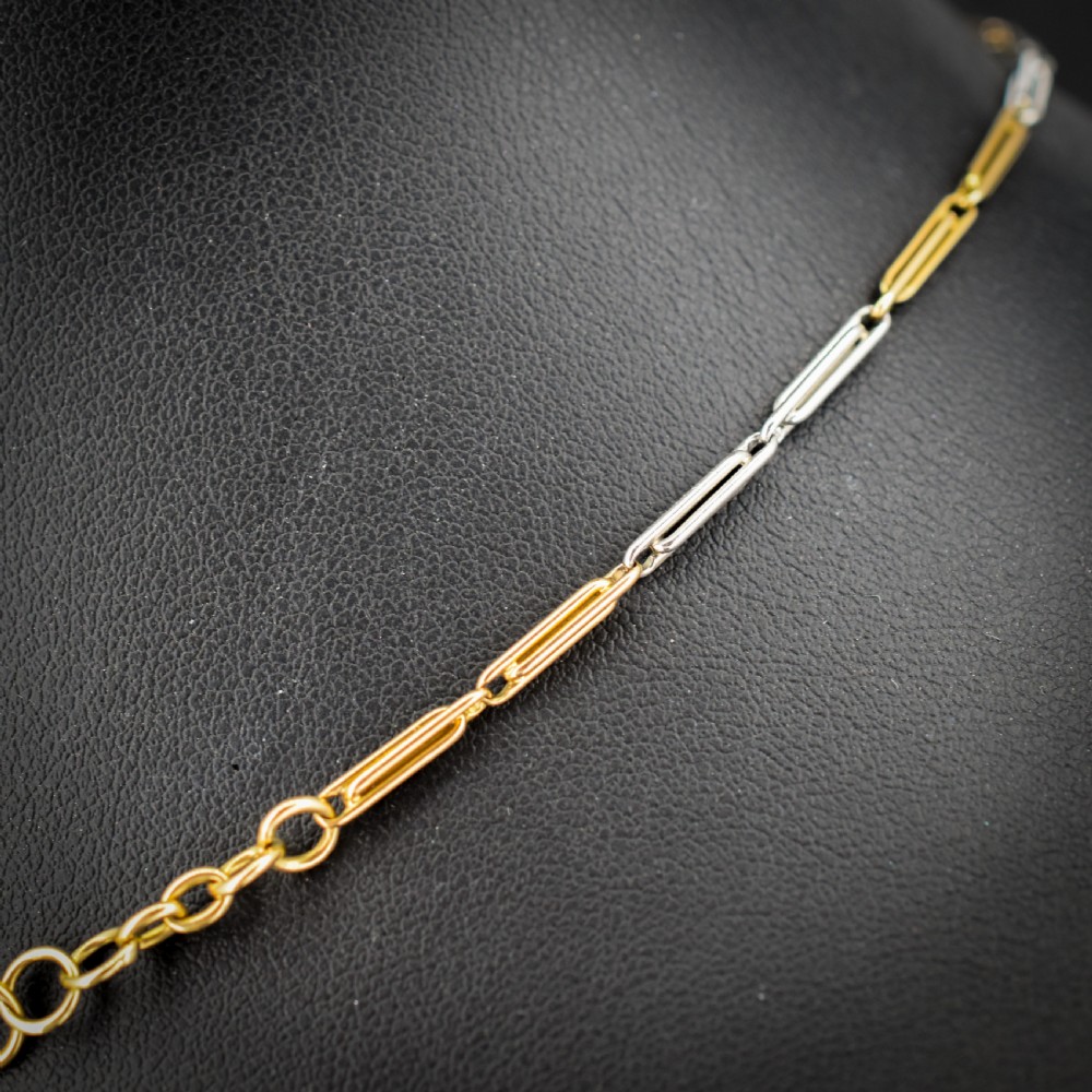 An antique two-tone chain necklace featuring alternating 18ct yellow gold and platinum elongated links with a dog clip and bolt ring clasp. View V